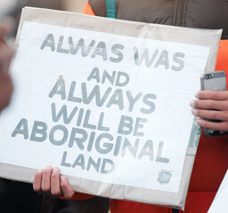 Person, protest and aboriginal with support, march and sign with demands, human rights and freedom....