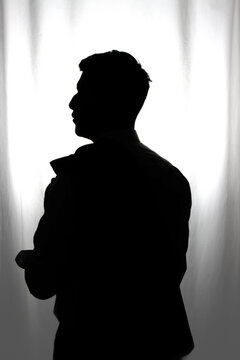 silhouette of a man cast in contalus