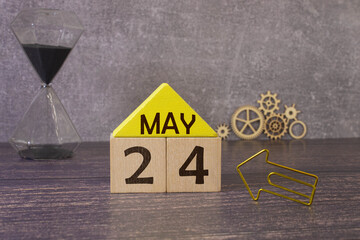 May 24th calendar date text on white wooden block on wooden desk