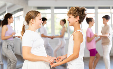 Fototapeta premium Boy and girl dancing ballroom waltz dance in studio