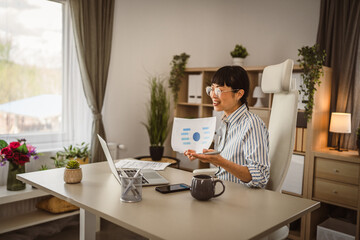 Mature japanese woman hold document and have consultation via video call