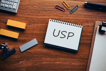 There is notebook with the word USP. It is an abbreviation for Unique Selling Proposition as...