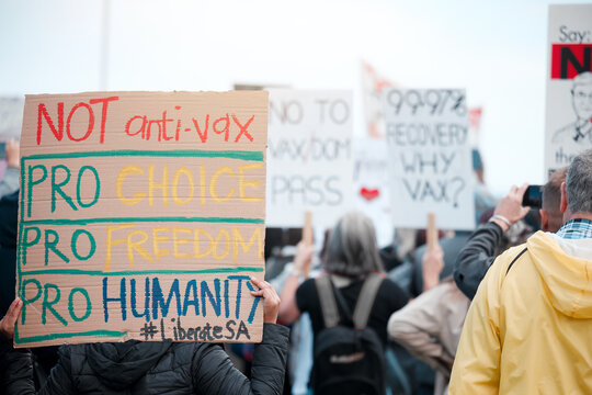 People, protest and sign with crowd for vaccine, opinion or poster for corona, medical or human rights. Group, support and fight to stop pharma crime for choice, decision or covid with voice in city