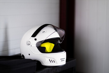 Competitor's white helmet and reflective vest, protective attire, ready for Castilla y León racing.
