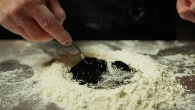 Chef Mixes The Dough With Flour Eggs And Cuttlefish Ink Food