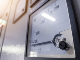 Close up the Analog Voltmeter with pointer and scale, maximum voltage on the panel power plant.