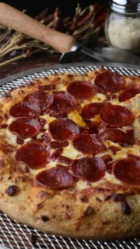 lifting up pepperoni pizza with extra cheese