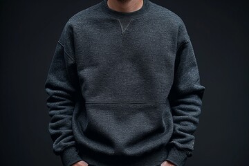 A man in a grey sweatshirt has his hands in his pockets - obrazy, fototapety, plakaty