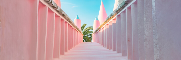 pink street perspective with walls towers and palm trees