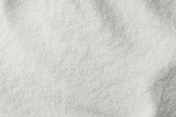 White granulated sugar as background, top view