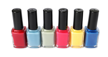 Obraz premium Bright nail polishes in bottles isolated on white