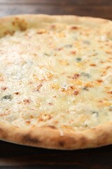 Delicious cheese pizza on wooden table, closeup