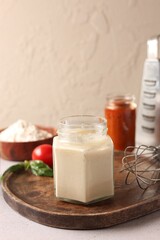 Pizza dough starter in glass jar and products on gray table