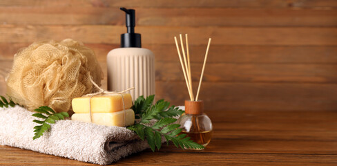 Composition with spa accessories and plant leaves on wooden background