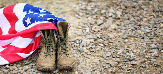 Military boots and USA flag outdoors. Memorial Day celebration