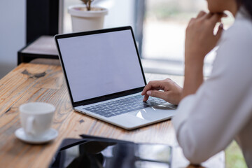 Fototapeta premium Closeup of hands typing on a laptop keyboard, Freelancer working on laptop at desk in loft office