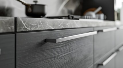 Close-up of luxury gray light kitchen cabinet doors with sleek stainless steel handles, vintage flair