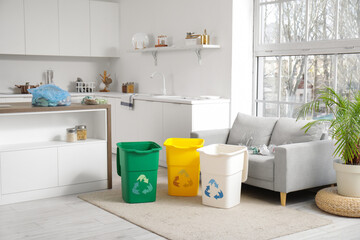Containers for garbage and different rubbish on sofa at home. Recycling concept