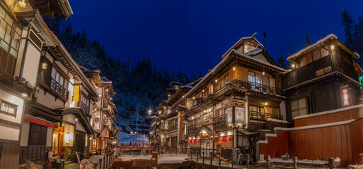 snowy winter evening in Ginzan Onsen, which is a famous hot spring town in Obanazawa, Yamagata,...