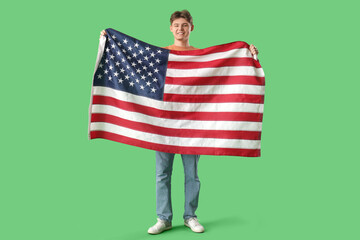 Young man with flag of USA on green background