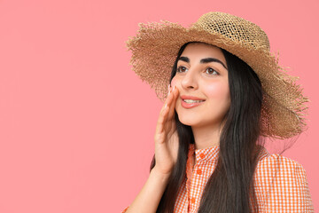 Beautiful young happy woman in straw hat on pink background. Festa Junina (June Festival) celebration