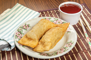 Chinese or asian chrispy wonton egg rolls on a white plate