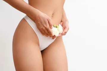 Foto op Plexiglas Beautiful young woman in panties with carnation flowers on white background, closeup © Pixel-Shot