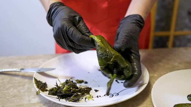 Chef deveins and cleans a poblano chile to make chiles stuffed with cheese 