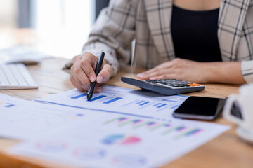 Business woman working at office with documents on his desk, doing planning analyzing the financial...