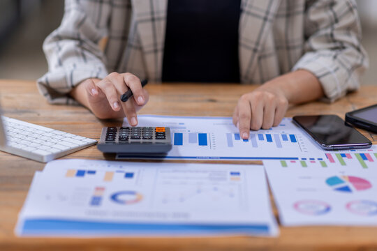 Business woman working at office with documents on his desk, doing planning analyzing the financial report, business plan investment, finance analysis concept	