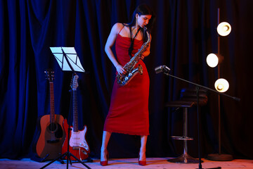 Beautiful woman playing saxophone on stage