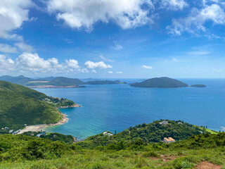 Fototapeta premium Panoramic View of Lush Greenery and Tranquil Ocean, Hong Kong Island