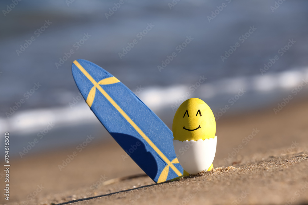 Sticker painter easter egg and surfboard on sea beach