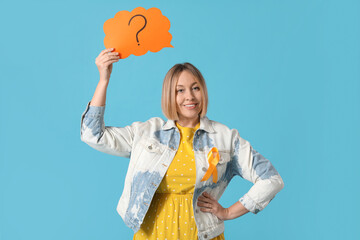 Happy mature woman with ribbon and speech bubble on blue background. Multiple Sclerosis Awareness...