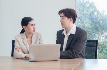 Business team woman and man asian group meeting sitting on desk looking talk creative idea hand holding computer on table ready for happy working newproject job online sale inside room office company.