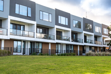 a row of multi level modern residential townhouses with balconies. Concept of real estate, housing market, Australian suburb, suburban homes and neighborhood community