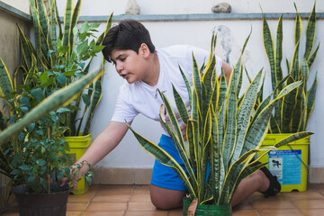 environmentally conscious child Watering plants in the urban garden
