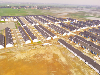 Housing Development in Bandung City - Indonesia. Aerial drone view of public housing on the edge of...