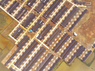 Row of houses in Bandung City from drone. Aerial drone view of public housing on the edge of the...