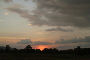 Sunset Sky cloud in the Morning Sunrise with Orange, Yellow Golden Hour Sunrise on Summer season, Horizon Dusk Sky Dramatic Nature Background