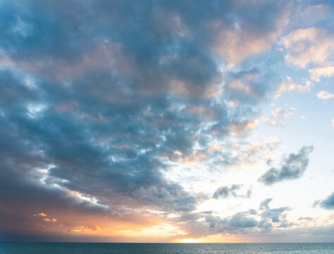 Vast cloudy sky at sunset over the ocean
