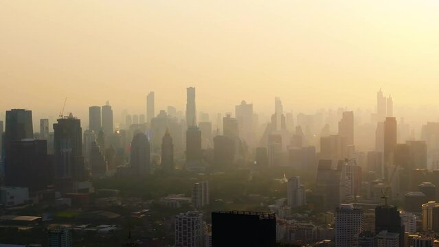 Cityscape in smog. Silhouettes of buildings in the haze. A city with dirty air due to fires. Air pollution. Problem of pollution of the environment. 