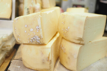 many type of cheeses on shop window
