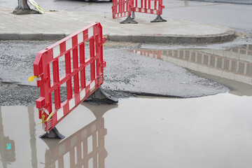 Big pot hole filled with water at street