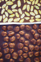 dark chocolate with mixed nut on black background 