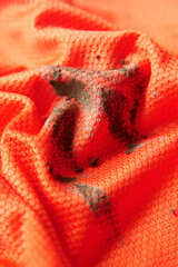 orange color cloth stain closeup 