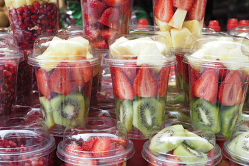 pineapple, kiwi and Strawberries in. plastic container selling at shop 