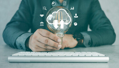 Businessman holding a light bulb and creative light bulb with marketing network icons on planning strategy, analysis solution and development, Modern business, Innovative of new ideas.