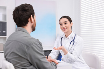 Fototapeta premium Doctor consulting patient during appointment in clinic
