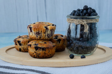 Homemade baked blueberry muffins with fresh harvested blackberries in glass jar. Tasty pastry sweet cupcake dessert. Berry pie Healthy vegan cupcakes with organic berries. Gluten free healthcare